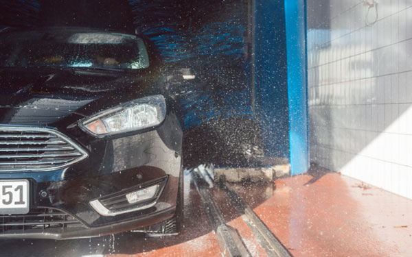 black sedan exiting an iba car wash