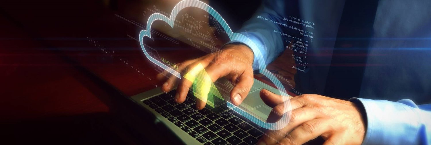 man's hands on a keyboard with a graphic of a cloud overlaid
