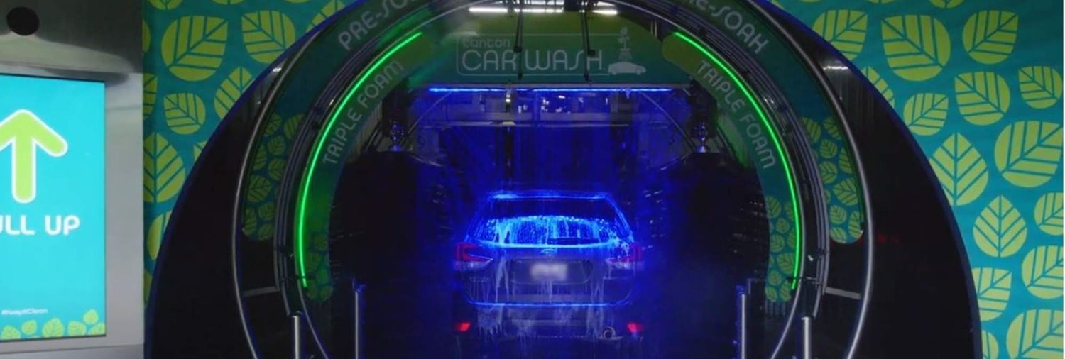 back of a vehicle going through a car wash tunnel