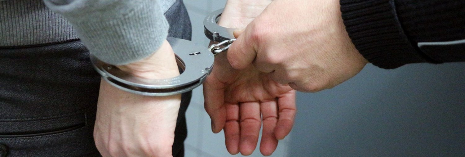 close up of someone's hands being handcuffed by someone else