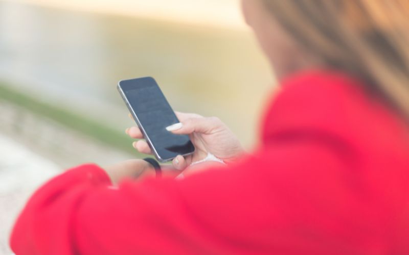 focus on women's hand holding a phone