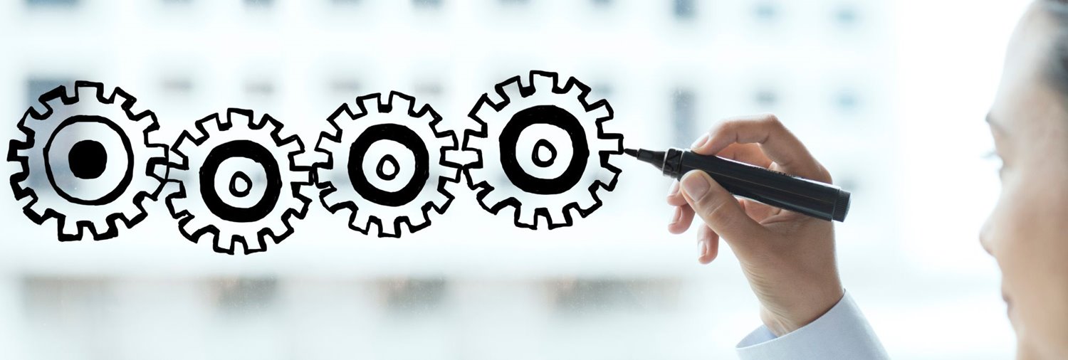 images of interlocking gears being drawn on glass with a dry erase marker