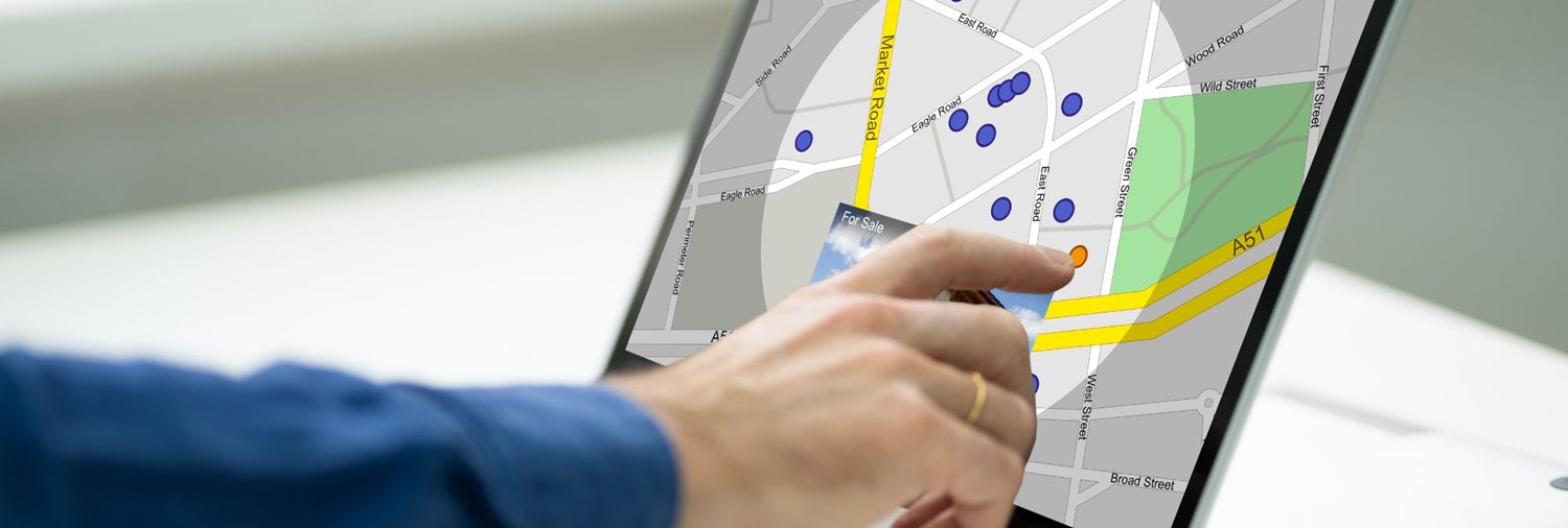 hand pointing at a location on a map on a computer screen