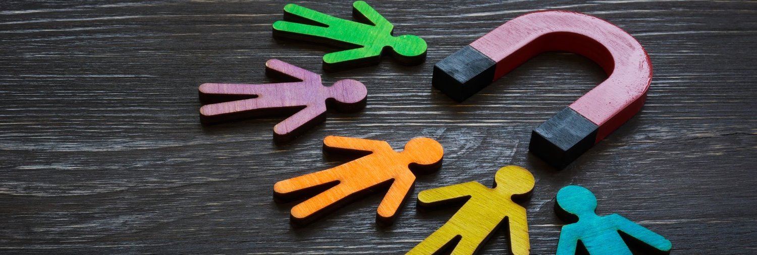 A wooden magnet attracting wooden figures