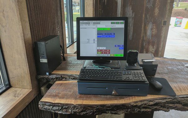 drb cashier terminal on a natural looking wood table or desk