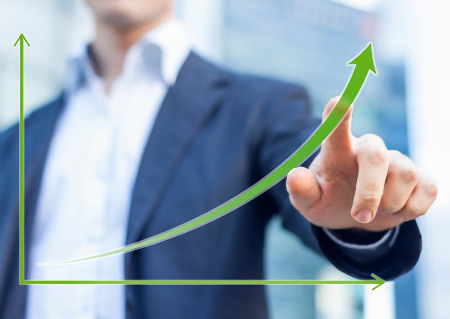 Graphic depicting growth with the blurred image of a man pointing at the upward arrow