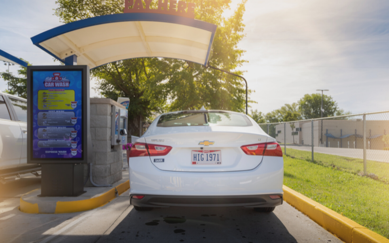 vehicle driving up to car wash pay station and being recognized by license plate recognition